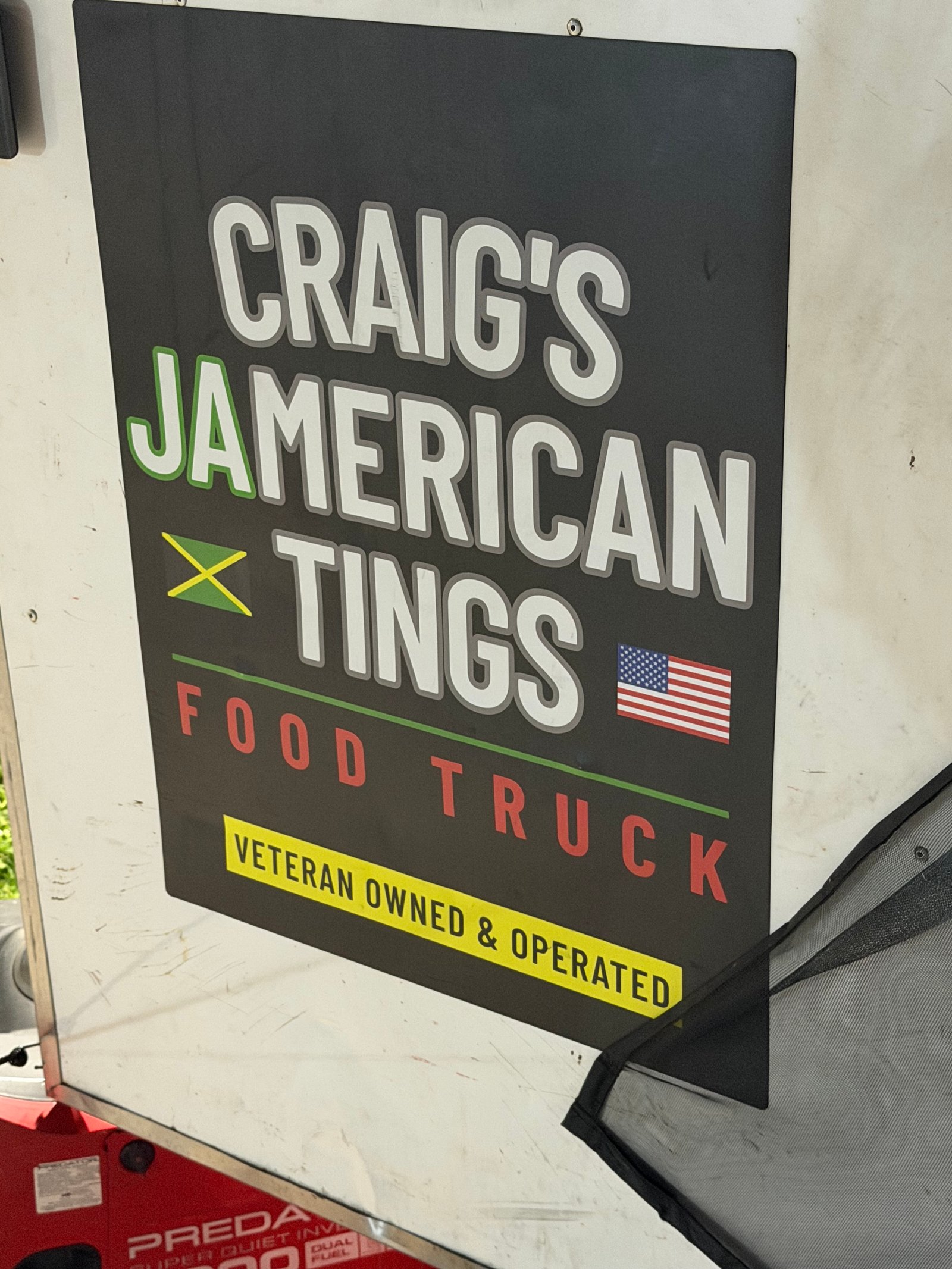 Craig's Jamerican Tings logo sign on the side of the truck